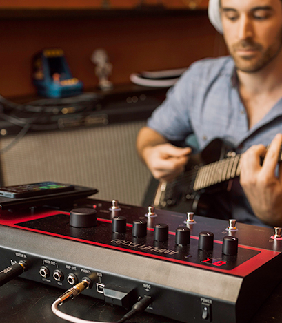 guitarist practicing on Line 6 FX100 guitar effects pedal